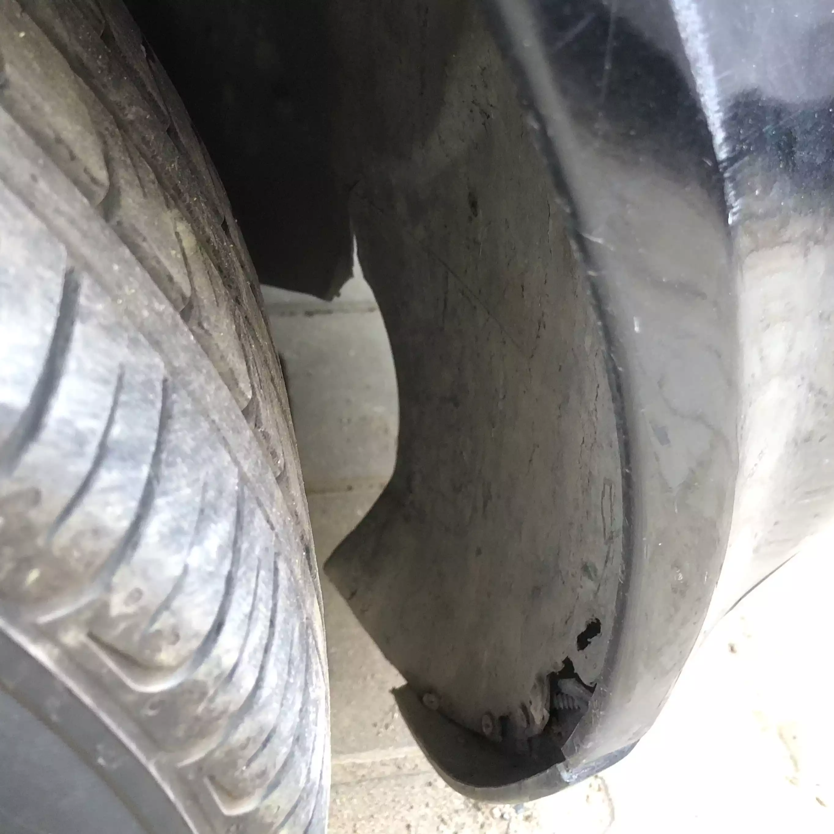 Damaged front wheel-arch liner.